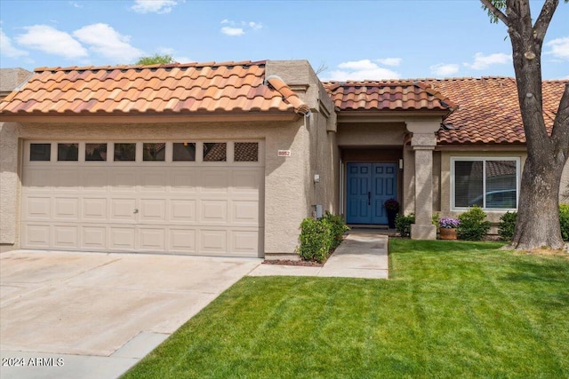 mediterranean / spanish-style house with a front lawn and a garage