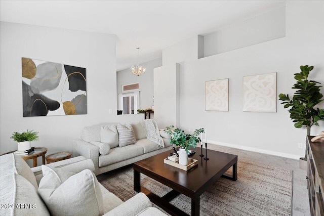 living room with a notable chandelier and dark colored carpet