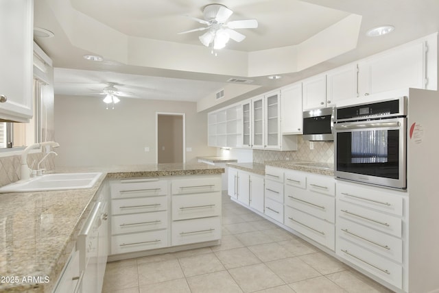 kitchen with white cabinets, sink, decorative backsplash, light tile patterned floors, and stainless steel appliances