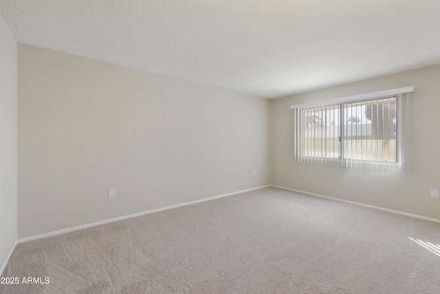 carpeted spare room featuring a textured ceiling