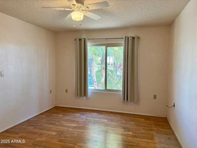 spare room featuring hardwood / wood-style flooring, a textured ceiling, and ceiling fan