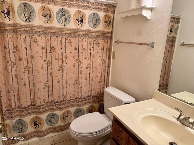 bathroom with vanity, toilet, and tile patterned flooring