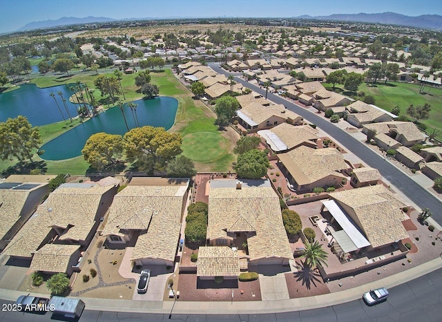 drone / aerial view featuring a water and mountain view