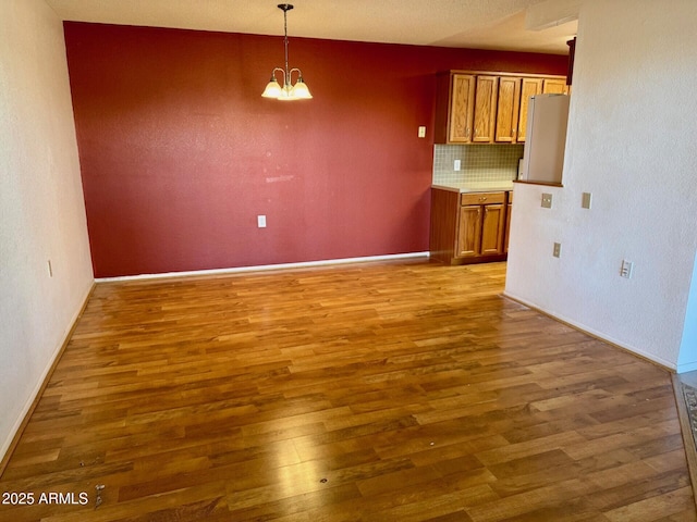 interior space featuring a chandelier and dark hardwood / wood-style flooring