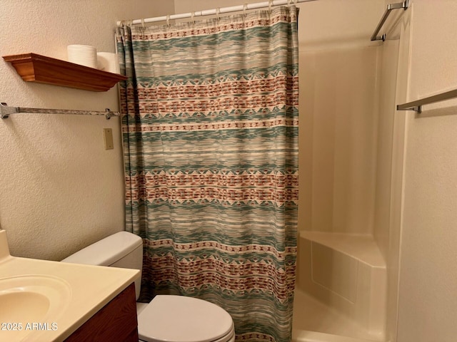 bathroom featuring vanity, toilet, and a shower with shower curtain