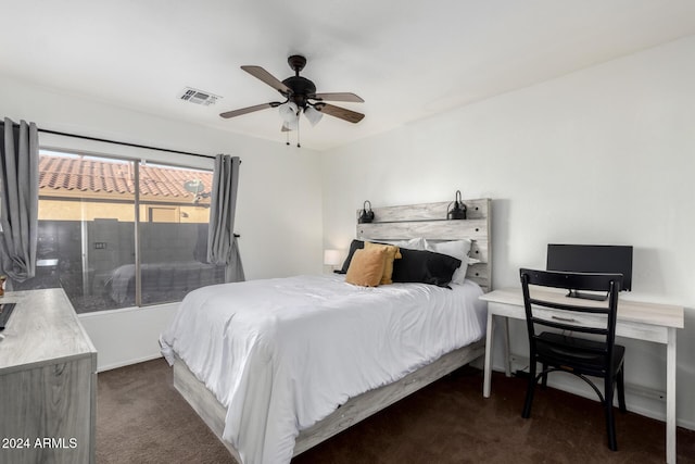 bedroom with ceiling fan and dark carpet