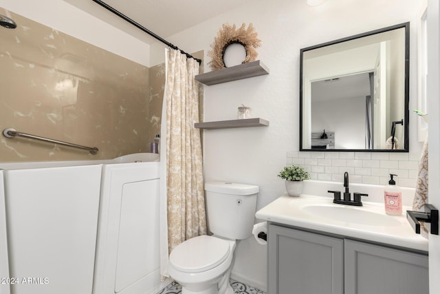 bathroom featuring decorative backsplash, vanity, and toilet