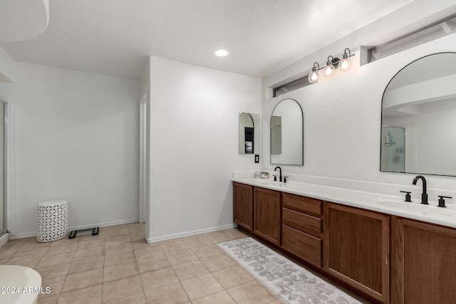 bathroom with tile patterned floors, vanity, and a shower with door