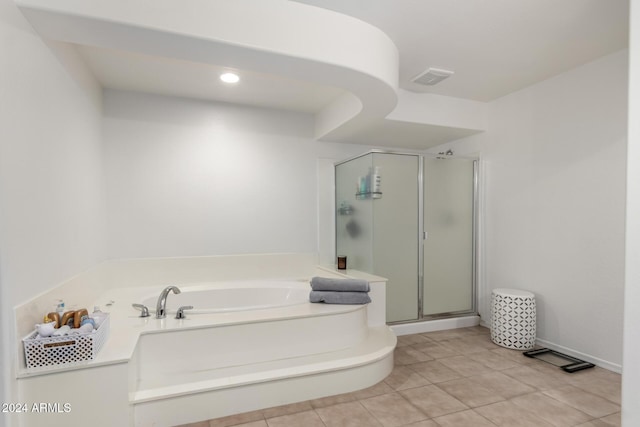 bathroom with tile patterned floors and shower with separate bathtub