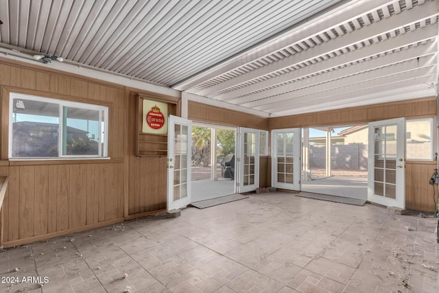 unfurnished sunroom with a wealth of natural light and french doors