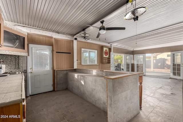 kitchen with ceiling fan, wooden ceiling, and kitchen peninsula