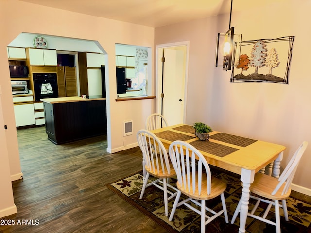 dining space featuring dark wood-type flooring