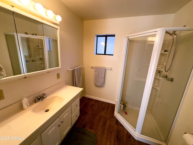 bathroom with vanity, hardwood / wood-style floors, and an enclosed shower