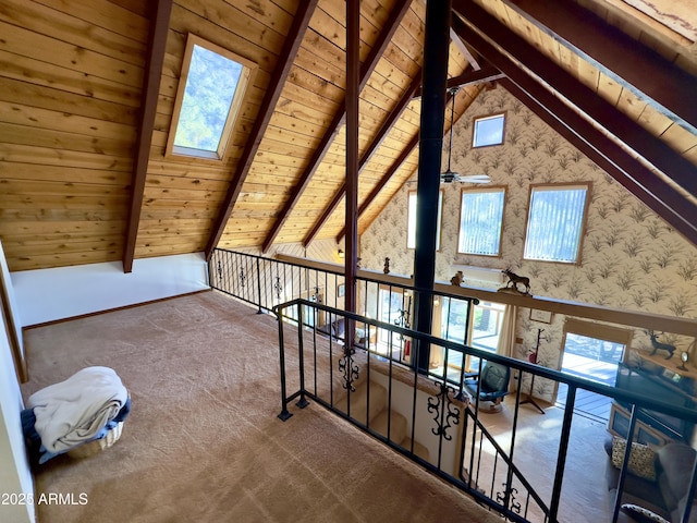 additional living space with wood ceiling, vaulted ceiling with skylight, and carpet floors