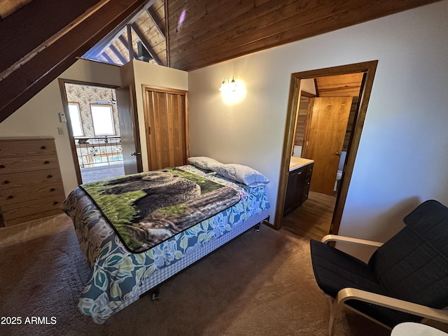 carpeted bedroom featuring vaulted ceiling, wooden ceiling, a closet, and ensuite bathroom