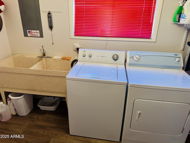 washroom featuring dark hardwood / wood-style floors, washing machine and clothes dryer, and electric panel