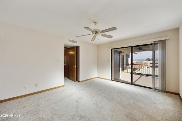 empty room with a ceiling fan, light colored carpet, visible vents, and baseboards