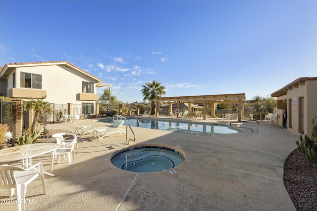 community pool featuring a patio area, fence, and a hot tub