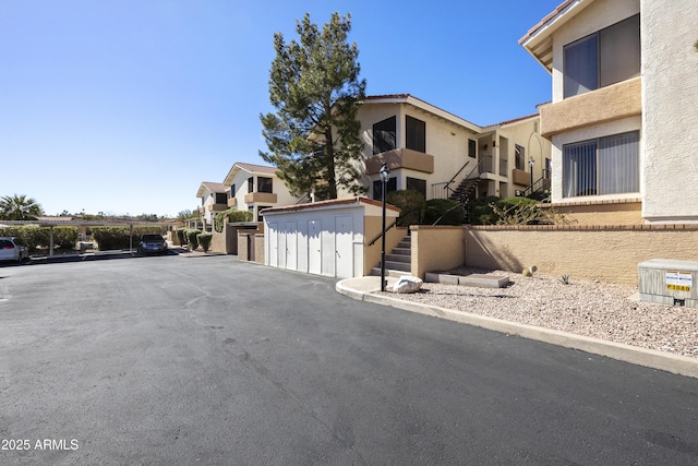 view of street with a residential view and stairway