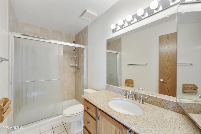 full bathroom with tile patterned floors, a shower stall, toilet, and vanity