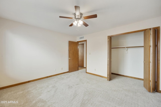 unfurnished bedroom featuring a closet, light colored carpet, visible vents, a ceiling fan, and baseboards