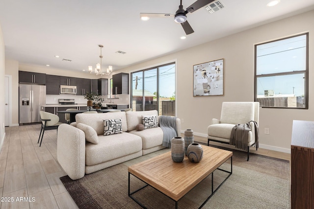 802 W Buist Ave, Phoenix, AZ 85041 - living room featuring a chandelier, recessed lighting, a ceiling fan, baseboards, and light wood-style flooring