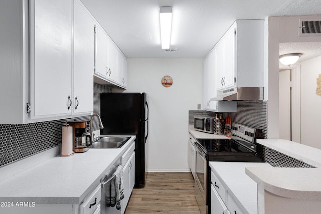 kitchen with backsplash, white cabinets, and appliances with stainless steel finishes