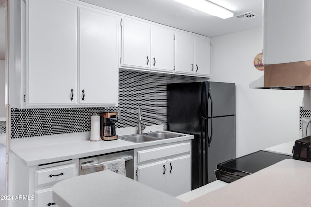 kitchen with light countertops, white cabinets, black appliances, backsplash, and a sink