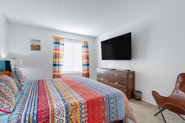 carpeted bedroom with a textured ceiling and baseboards