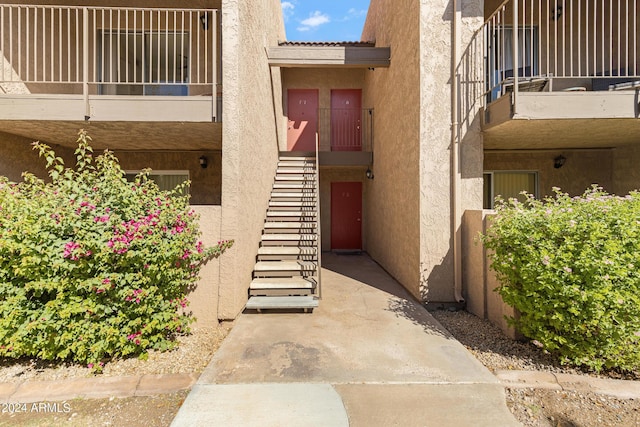 entrance to property featuring stucco siding