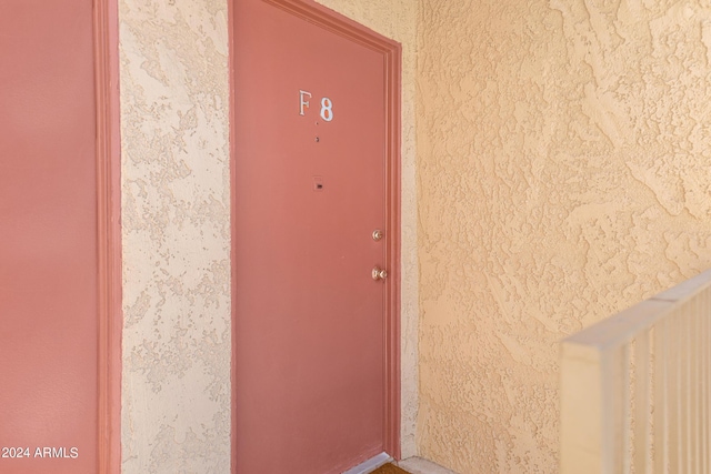 entrance to property with stucco siding
