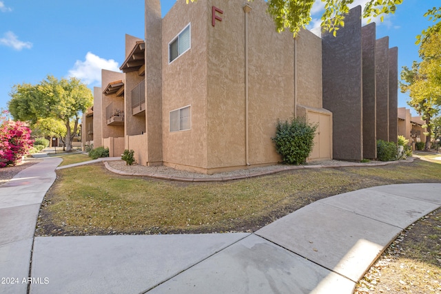 view of property exterior with a lawn