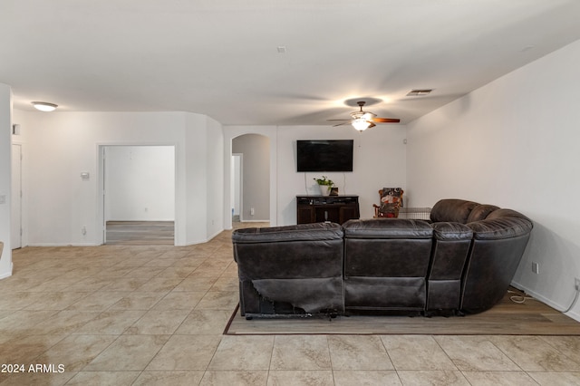 tiled living room featuring ceiling fan