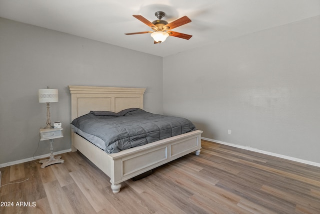 bedroom with ceiling fan and hardwood / wood-style flooring