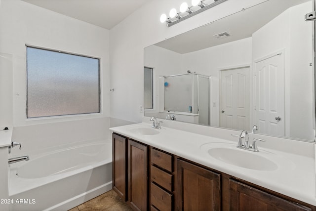 bathroom featuring tile patterned flooring, plus walk in shower, and vanity