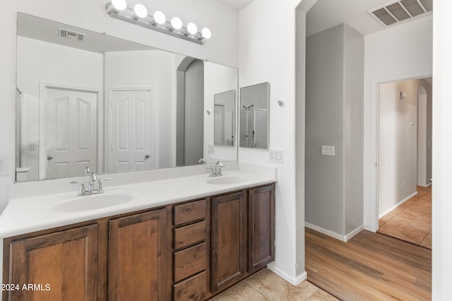 bathroom with vanity and wood-type flooring