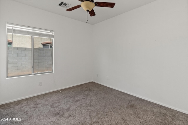 spare room with ceiling fan and carpet