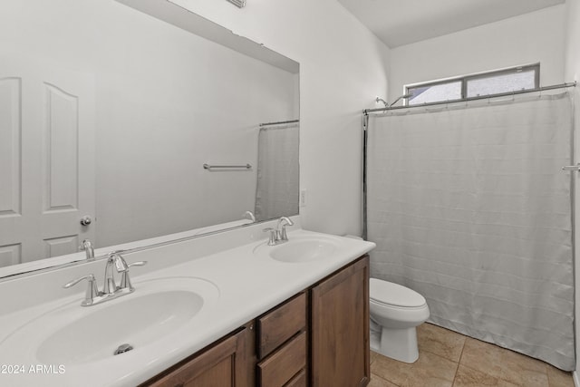 bathroom with toilet, vanity, curtained shower, and tile patterned floors