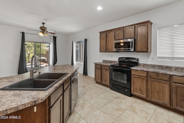 kitchen with sink, stainless steel appliances, ceiling fan, and light tile patterned flooring