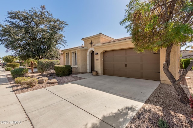 view of front of home featuring a garage, driveway, and stucco siding