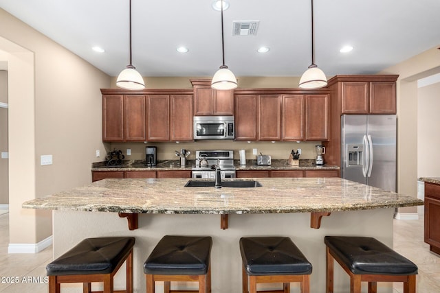 815 E Laddoos Ave, San Tan Valley, AZ 85140 - kitchen featuring stainless steel appliances, an island with sink, visible vents, and decorative light fixtures