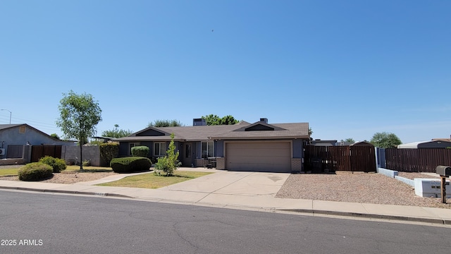 5539 E Dragoon Ave, Mesa, AZ 85206 - ranch-style house featuring an attached garage, driveway, brick siding, and a gate