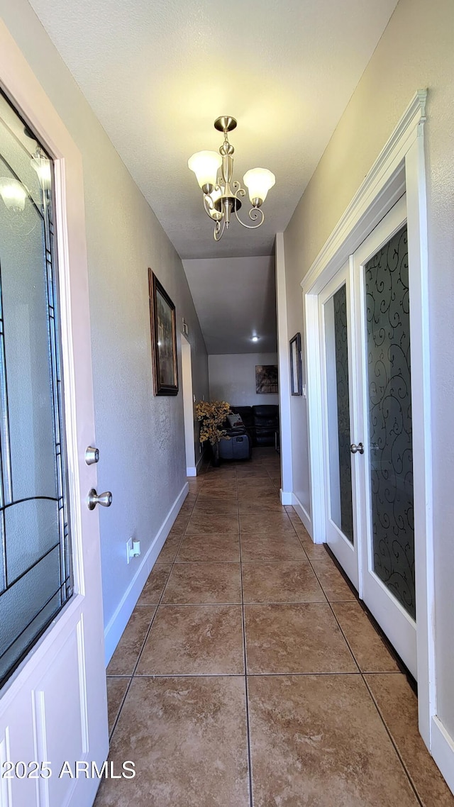 5539 E Dragoon Ave, Mesa, AZ 85206 - corridor featuring french doors, a chandelier, tile patterned flooring, and lofted ceiling