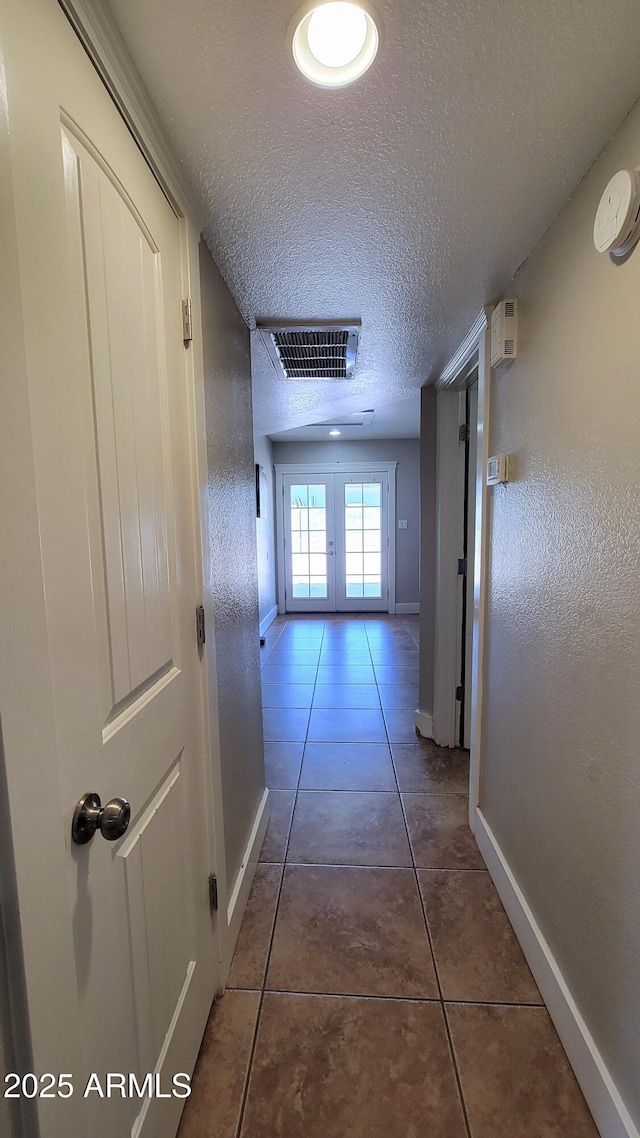 5539 E Dragoon Ave, Mesa, AZ 85206 - corridor featuring a textured ceiling, french doors, and tile patterned floors