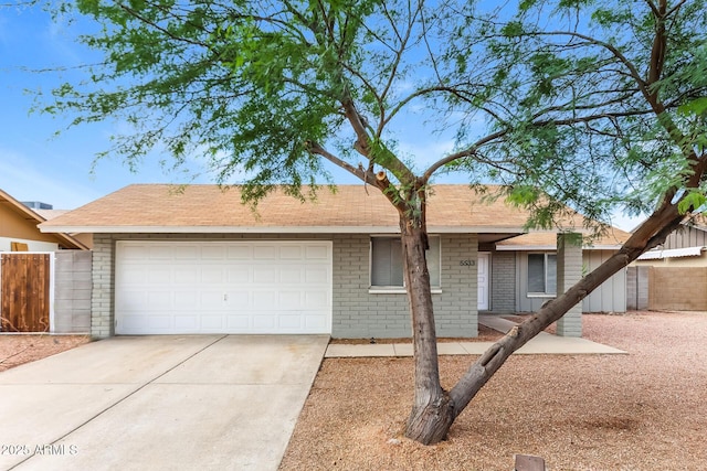 5533 W Sunnyside Dr, Glendale, AZ 85304 - ranch-style home featuring an attached garage, concrete driveway, brick siding, and a shingled roof