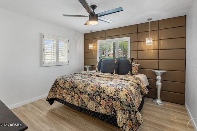 7707 E Earll Dr, Scottsdale, AZ 85251 - bedroom with light wood-style floors, baseboards, and a ceiling fan