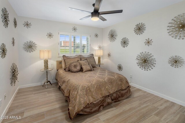 7707 E Earll Dr, Scottsdale, AZ 85251 - bedroom with light wood finished floors, baseboards, and a ceiling fan