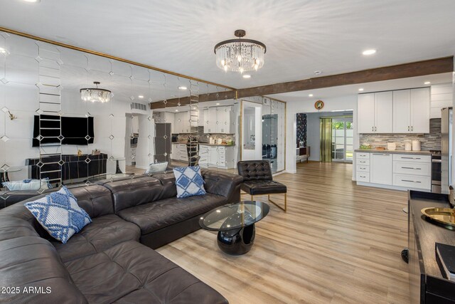 7707 E Earll Dr, Scottsdale, AZ 85251 - living room featuring a chandelier, light wood-style flooring, and recessed lighting