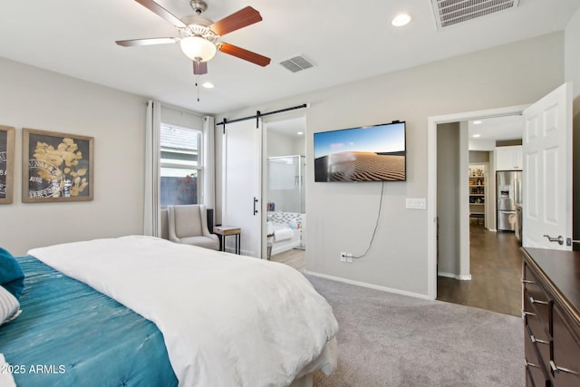 bedroom with a barn door, carpet floors, stainless steel fridge, and ceiling fan