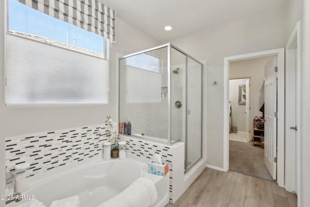 bathroom featuring hardwood / wood-style flooring and independent shower and bath